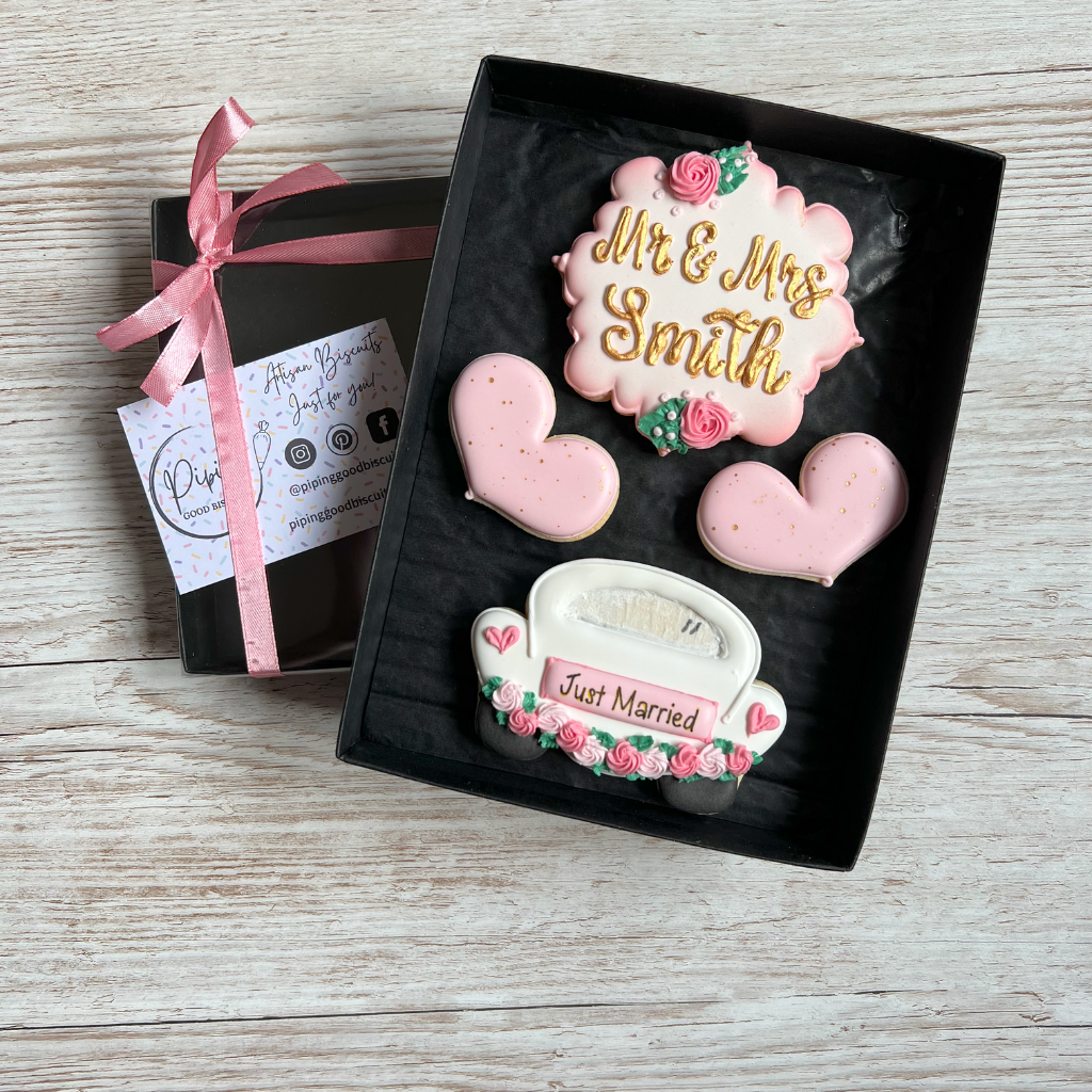 pink and white wedding biscuits including wedding car shape and plaque with names
