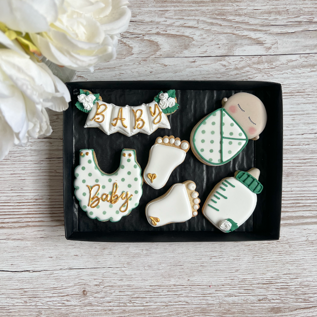 white green and gold royal iced biscuits for a new parents gift