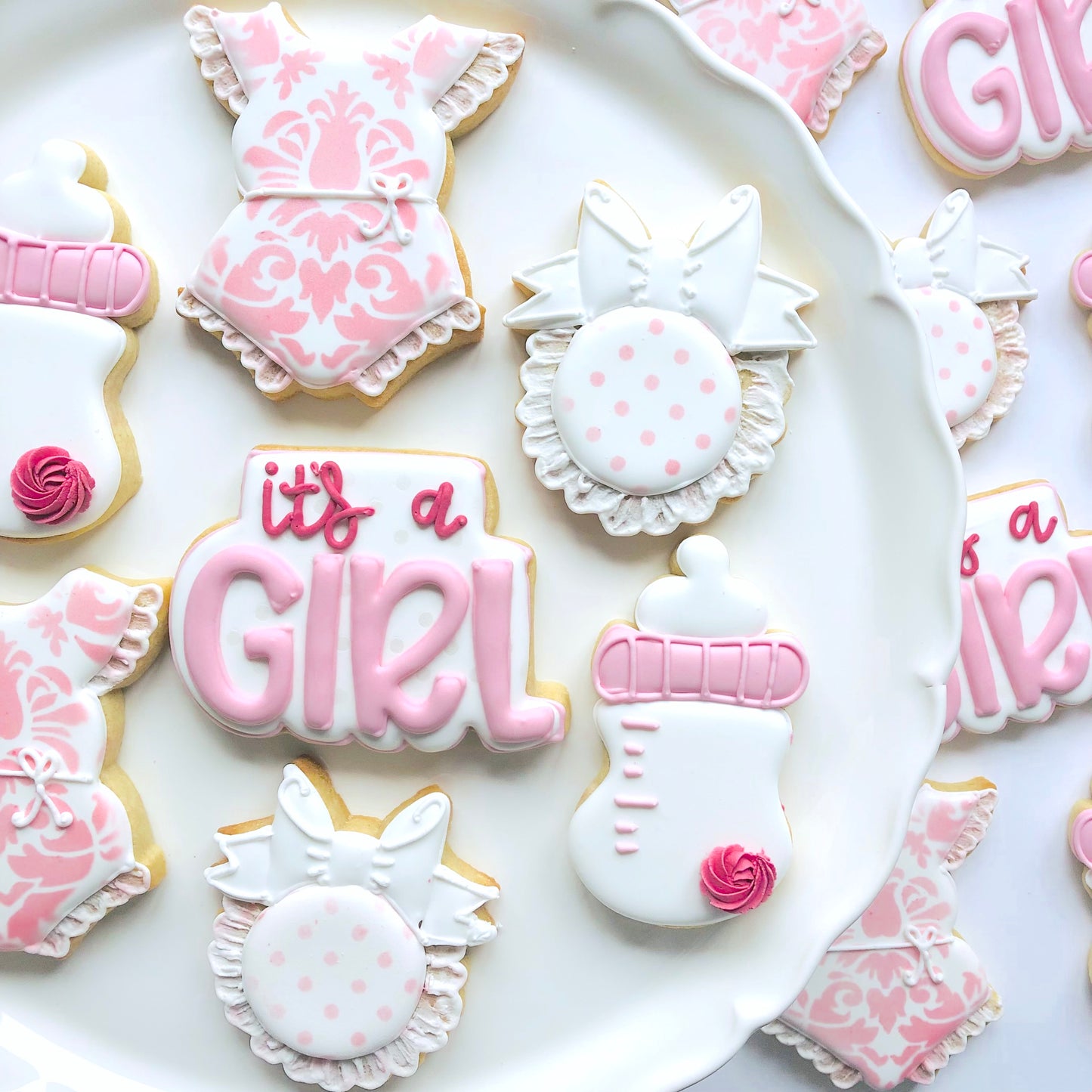 pink and white iced biscuits for a baby shower