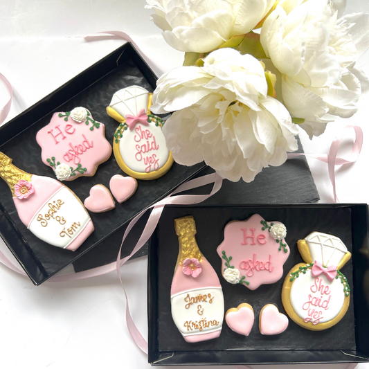 iced engagement biscuits with champagne bottle and ring shaped biscuits